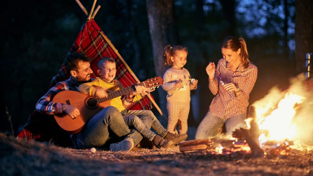 mindful parents enjoying a camp fire with children